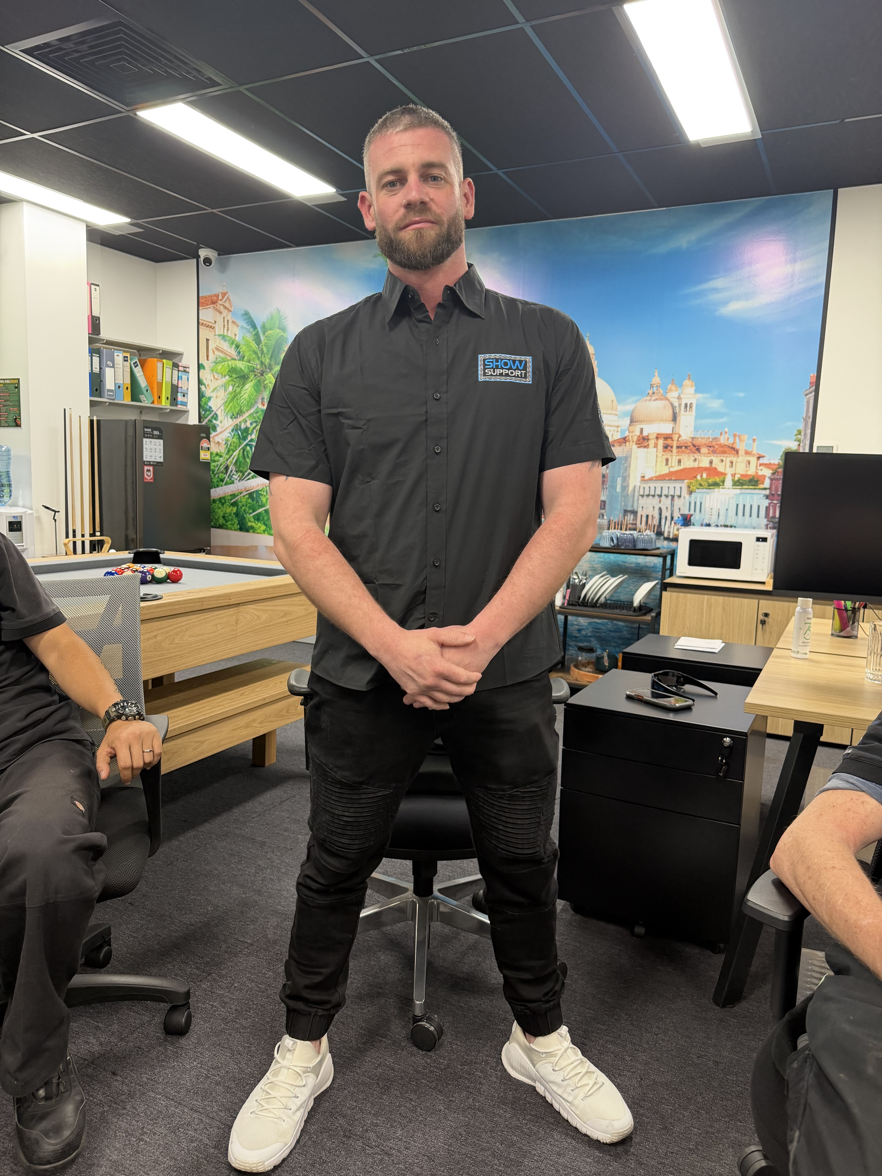 Sam Davis displaying the front of the Show Support Section Manager uniform